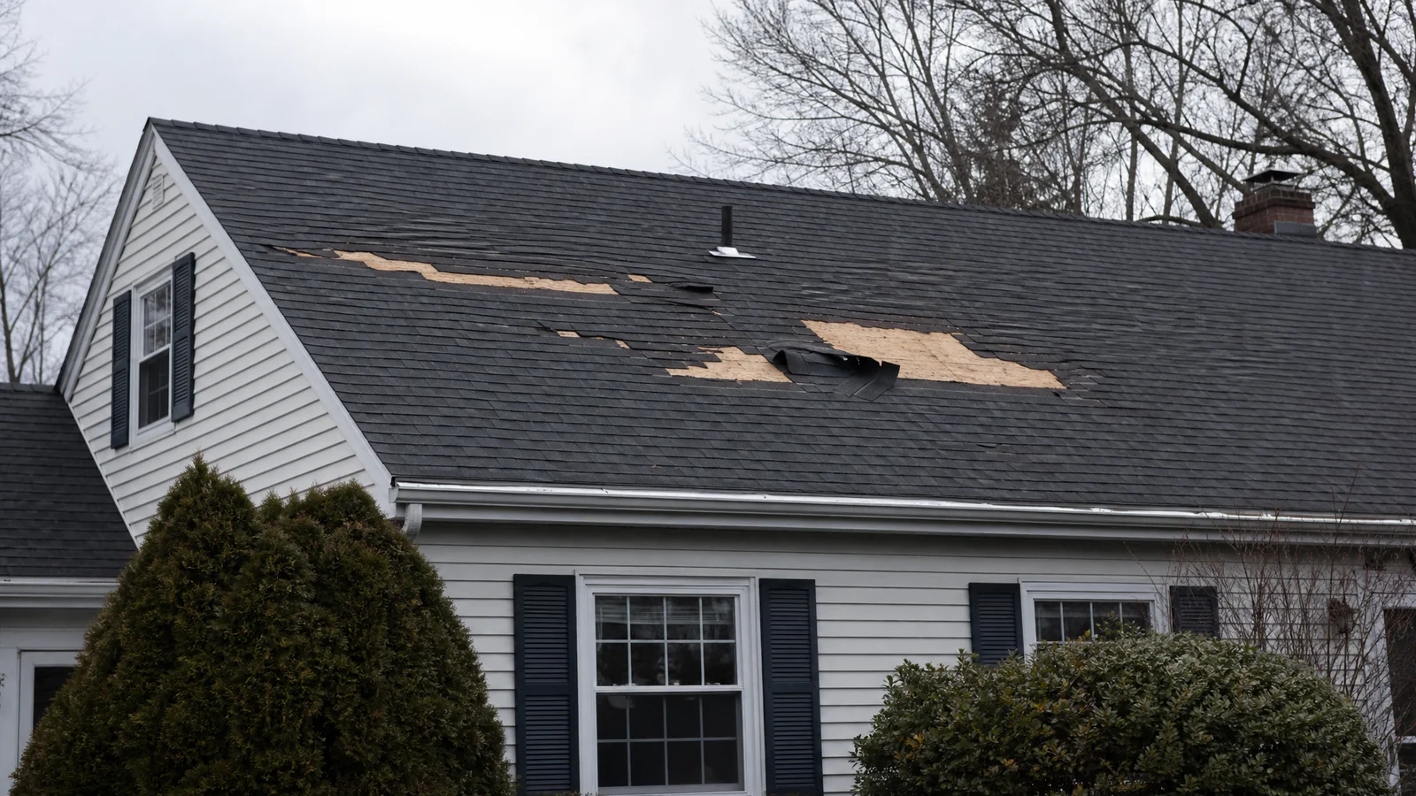 Roof with several missing shingles after wind