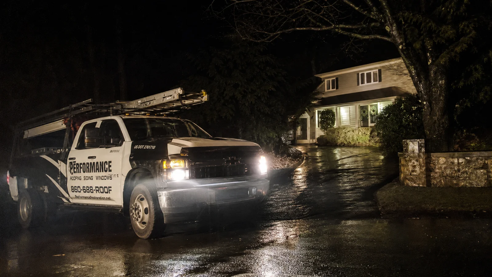 Emergency roofing truck arriving at night
